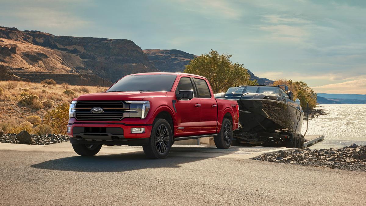 Ford F-150 towing a boat at a lakeside launch